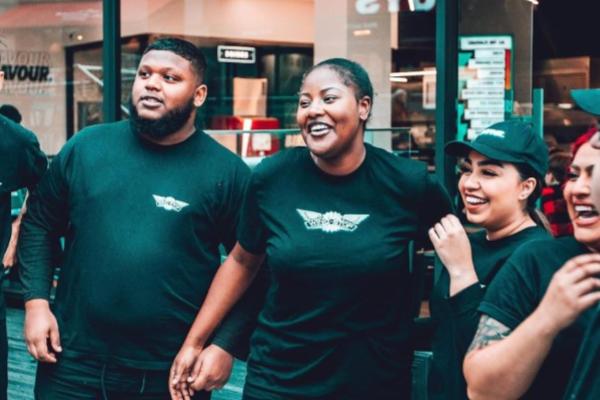 Wingstop team members posing for a picture